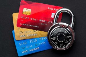 A padlock placed on top of credit cards, symbolizing card security and protection against financial fraud.