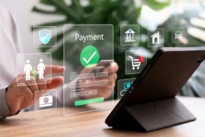 Person using a tablet to make an online payment through a transparent digital interface, representing the growth of e-commerce and the expanding role of the digital economy in modern financial transactions.